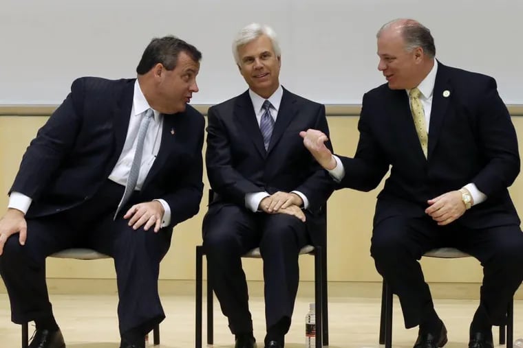 New Jersey Senate President Stephen M. Sweeney (right) gestures as then-Gov. Chris Christie (left) talks with influential Democrat George E. Norcross III.