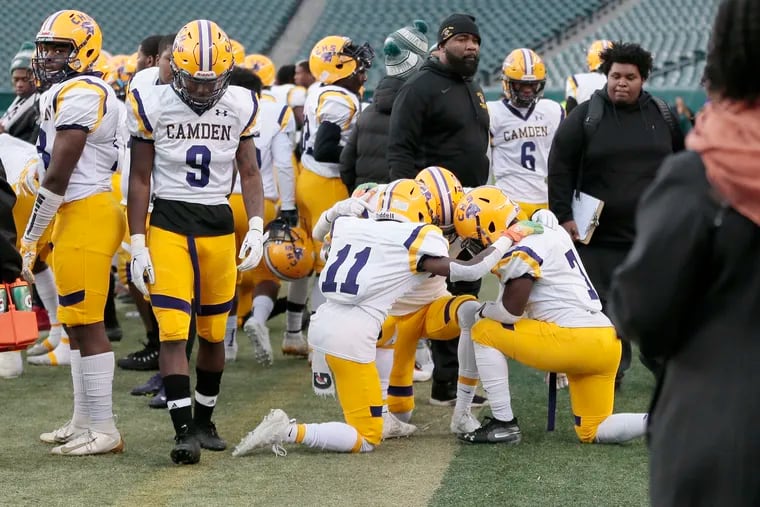 Several Camden players, including No. 11 Zaire Harris, pray together before the Panthers' state-playoff game at Lincoln Financial Field on Wednesday against Pleasantville.