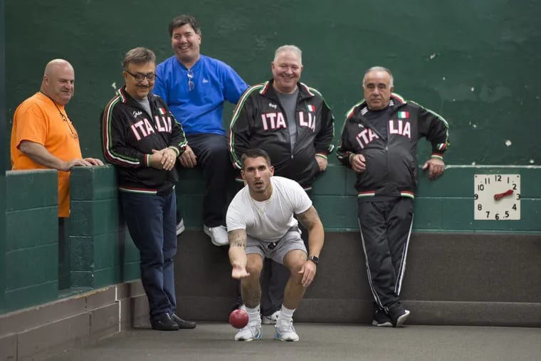 Adam Ribaudo bowls during the weekly South Philadelphia Bocce League games at the Guerin Recreation Center in South Philadelphia. Behind him are team members (in Italia jackets, left to right) John Palella, Perry Coco, and Ralph Lombardi.