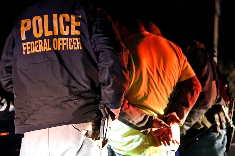 U.S. Immigration and Customs Enforcement agents surround and detain a person during a 2018 raid in Richmond, Va. ICE's enforcement and removal operations, like the five-person field office team outside Richmond, hunt people in the U.S. illegally, some of whom have been here for decades, working and raising families.