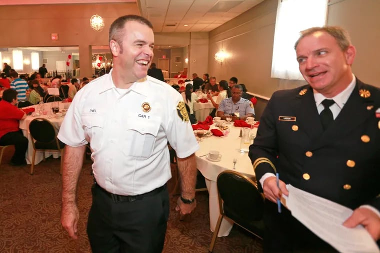 New fire commissioner Adam Thiel, left,  the former chief of the Alexandria, VA fire department, shares a laugh with Gary Loesch, right, deputy chief.