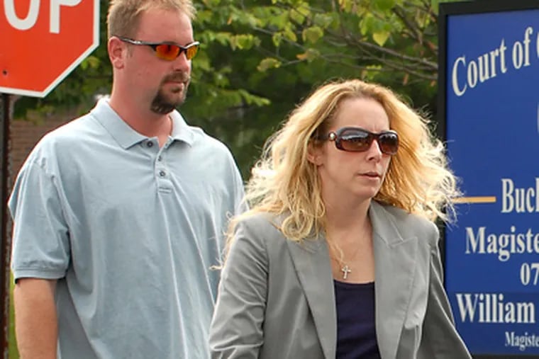 Bonnie Sweeten is accompanied by her husband Richard L. Sweeten (left) as she arrives at District Court in Richboro for a preliminary hearing on June 22. (Tom Gralish / Staff Photographer)