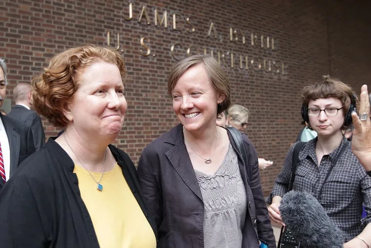 Cara Palladino, 48, left, and Isabelle Barker, 42, right, exit the Federal Courthouse. ( DAVID MAIALETTI / Staff Photographer )