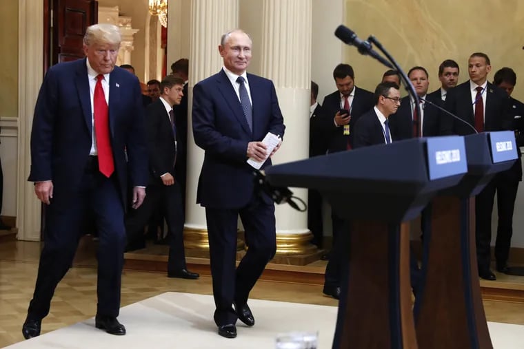 U.S. President Donald Trump, left, and Russian President Vladimir Putin arrive for a press conference after the meeting of U.S. President Donald Trump and Russian President Vladimir Putin at the Presidential Palace in Helsinki, Finland, Monday, July 16, 2018.