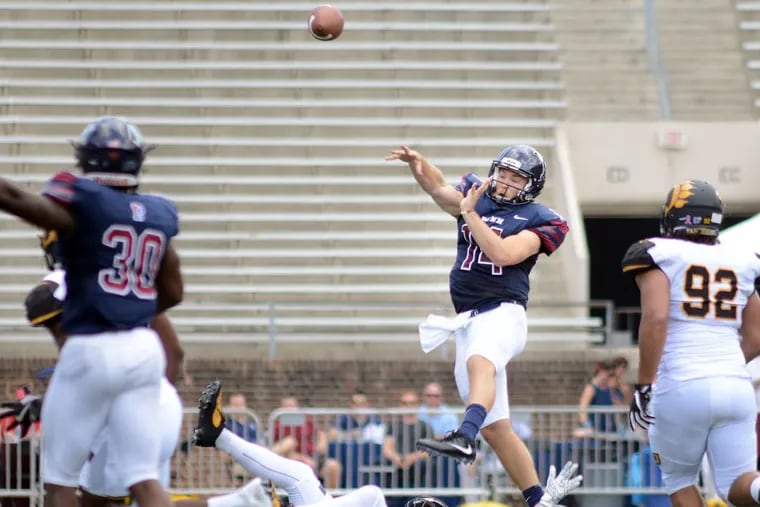 Penn quarterback Will Fischer-Colbrie (14) makes a pass after almost getting sacked against Ohio Dominican on Sept. 16 at Franklin Field.
