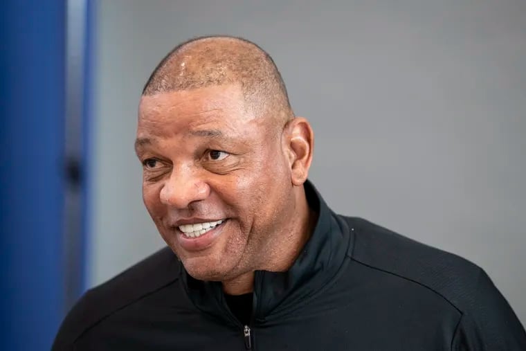 Sixers head coach Doc Rivers laughs during media day at their training complex in Camden.
