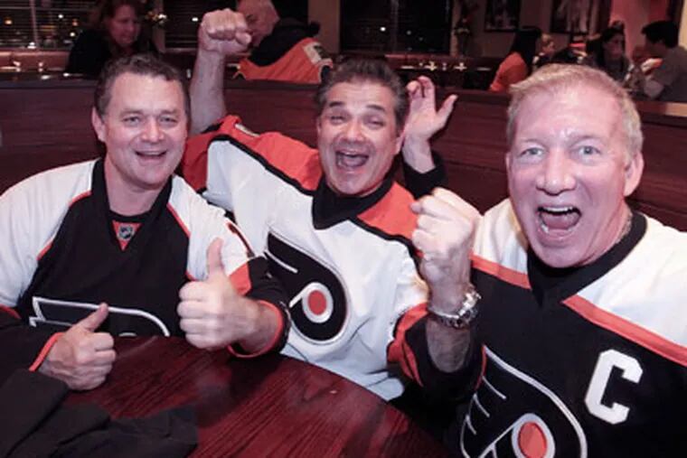 Flyers fans (from left) Ray Fitz, Dr. Rob DiMaio and team captain Joseph Daly sure seem content watching the playoffs at Xfinity Live!