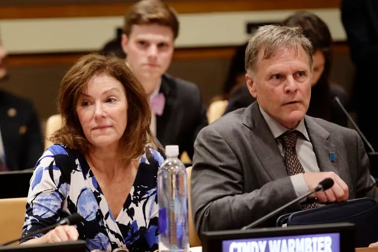 FILE - In this May 3, 2018, file photo, Fred Warmbier, right, and Cindy Warmbier, parents of Otto Warmbier, wait for a meeting at the United Nations headquarters.  A federal judge has ordered North Korea to pay more than $500 million in a wrongful death suit filed by the parents of Otto Warmbier, an American college student who died shortly after being released from that country. (AP Photo/Frank Franklin II, File)