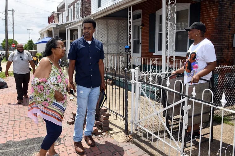 Michael T. Doweary (middle), Receiver for the City of Chester, talking with Zulene Mayfield (left), founder of Chester Residents Concerned For Quality Living, and resident Valerie Morse after a community meeting on June 26, 2021.