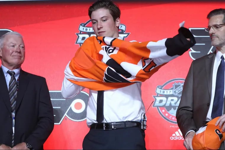 First-round pick Nolan Patrick tries a Flyers jersey on for size.