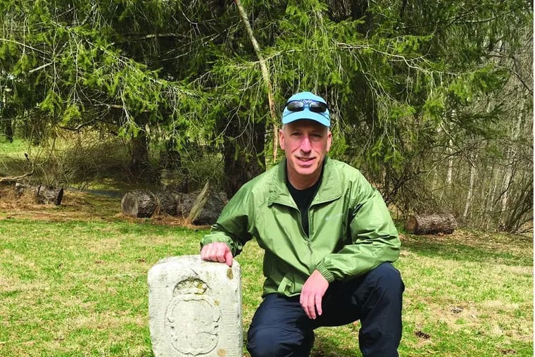 Eric Gladhill, a professional surveyor who grew up within a thousand feet of the Mason-Dixon line, with marker No. 85. The limestone marker was placed here in 1767 by workmen under the direction of Charles Mason and Jeremiah Dixon, two English scientists who were nearing completion of a five-year survey that drew a line between two American colonies. It is designated No. 85 because it is 85 miles from the beginning of the east-west Mason-Dixon Line near Newark, Del.