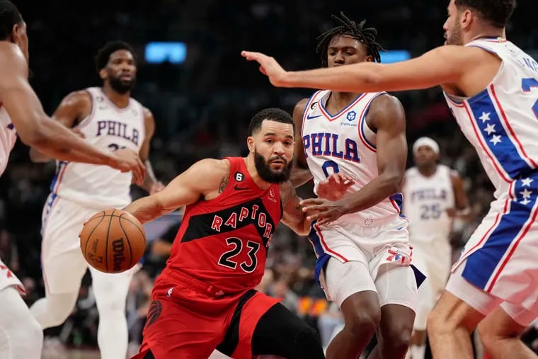 Toronto Raptors guard Fred VanVleet (23) drives as Philadelphia 76ers guard Tyrese Maxey (0) and forward Georges Niang (20) defend during the first half of an NBA basketball game, Wednesday, Oct. 26, 2022 in Toronto. (Frank Gunn/The Canadian Press via AP)