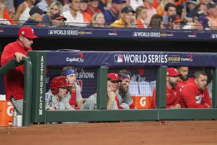 Manager Rob Thomson (left) and the Phillies dugout during the eighth inning of  Game 6.
