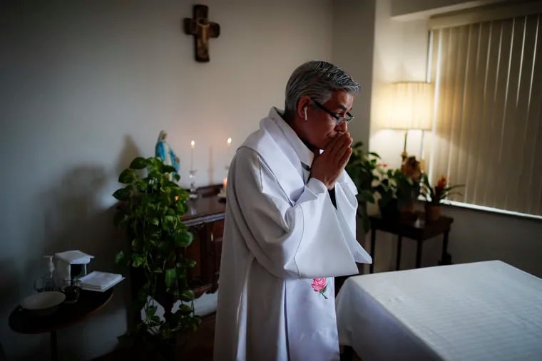 Fabian Arias, a Lutheran pastor with Saint Peter's Church in Manhattan, prepares to give Sunday services at his home via an internet livestream broadcast.