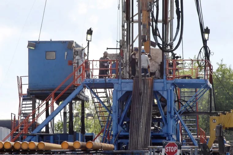A crew works on a gas-drilling rig.