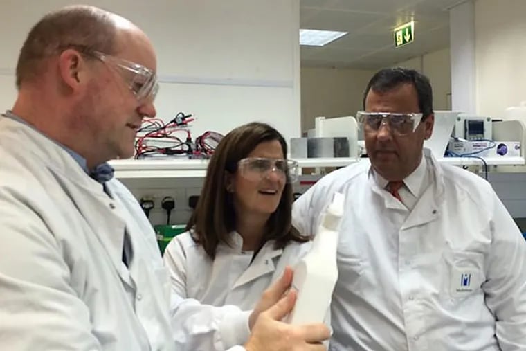 Gov. Christie, right, and his wife, Mary Pat, center, tour a research lab in Cambridge, England, on his trade mission to the United Kingdom. MADDIE HANNAH / Staff