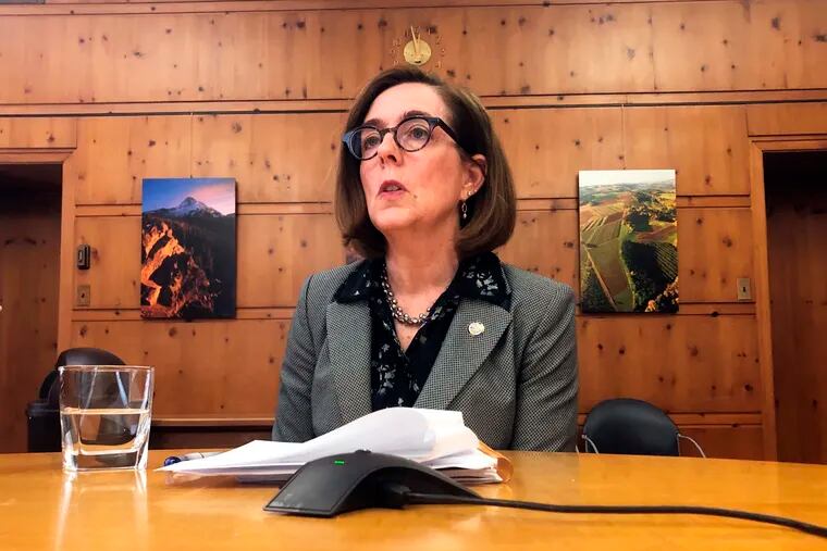 FILE - In this Monday, July 1, 2019, file photo, Oregon Gov. Kate Brown speaks with the media at the Capitol in Salem, Ore. (AP Photo/Sarah Zimmerman, File)