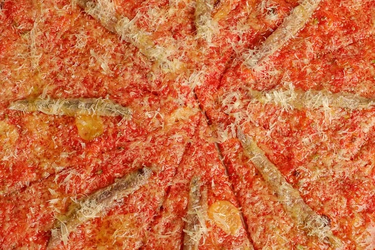 A pizza with tomato, anchovy, garlic, oregano, royer mountain cheese from Pizzeria Beddia in Fishtown.