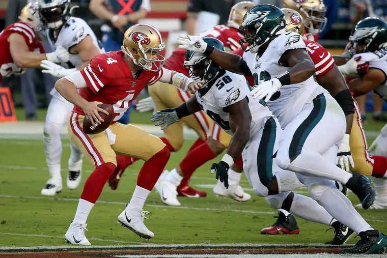 49ers quarterback Nick Mullens felt the pressure from Eagles defensive end Genard Avery (center) and Eagles nose tackle Javon Hargrave (right) during last year's game in San Francisco.