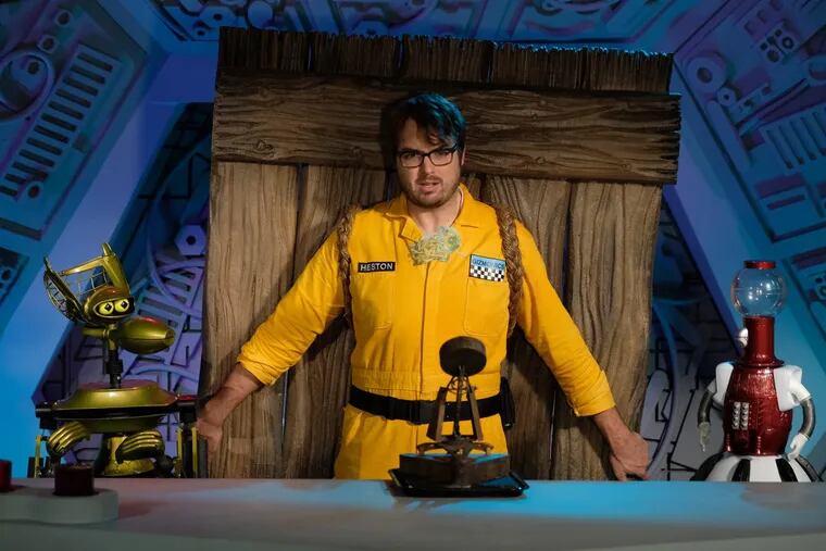 ‘Mystery Science Theater 3000’ will hold two live shows in Philadelphia this summer. Here, Jonah Ray, host of the MST3K reboot on Netflix, poses with Tom Servo and Crow T. Robot. (Darren Michaels/SMPSP/Netflix)