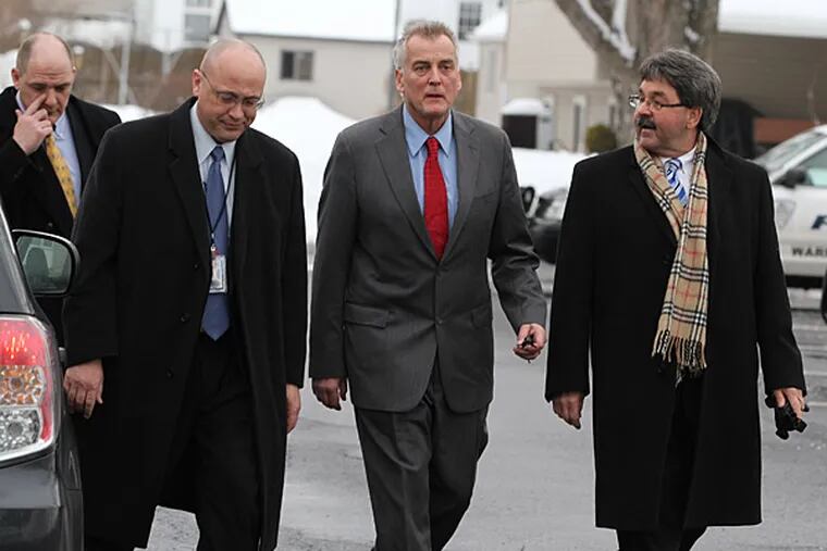 File photo: Don Tollefson, second from right, walks with his lawyer, Michael McGovern, right, as he turns himself in to Warminster police on Tuesday February 18, 2014, to face fraud charges. ( MICHAEL BRYANT / Staff Photographer )