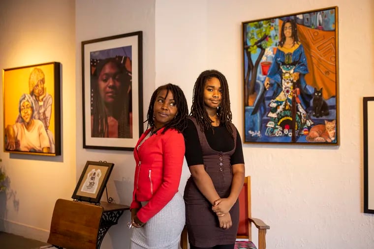 Tara “Misty Sol” Pearson (left), 42, and her daughter Ayah Pearson, 15, pose for a portrait near Tara’s art piece “Moorish Chieftess and Blue,” at the Slought for the new exhibit, “The First Time Ever I Saw Your Face.”