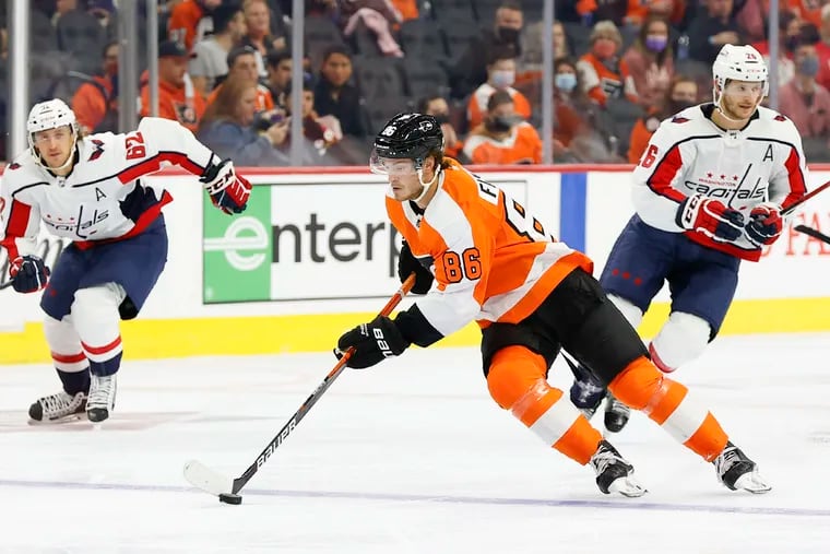 Flyers left wing Joel Farabee skates with the puck against Washington Capitals left wing Carl Hagelin (left) and center Nic Dowd in a preseason game on Saturday, October 2, 2021 in Philadelphia.