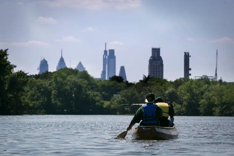 Philadelphia's skyline is visible over trees from the Cooper River in Camden, NJ, on the afternoon of Friday, June 29, 2018. Students enrolled in the UrbanTrekkers program through Urban Promise Academy in Camden, NJ, led the canoe trip on the river. These teens are employed as RiverGuides for the summer and are trained in the ecology and history of the river, as well as canoe safety.