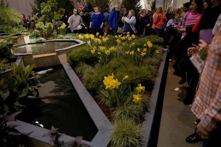 Attendees admire a landscape display during the first day of the annual Philadelphia Flower Show.