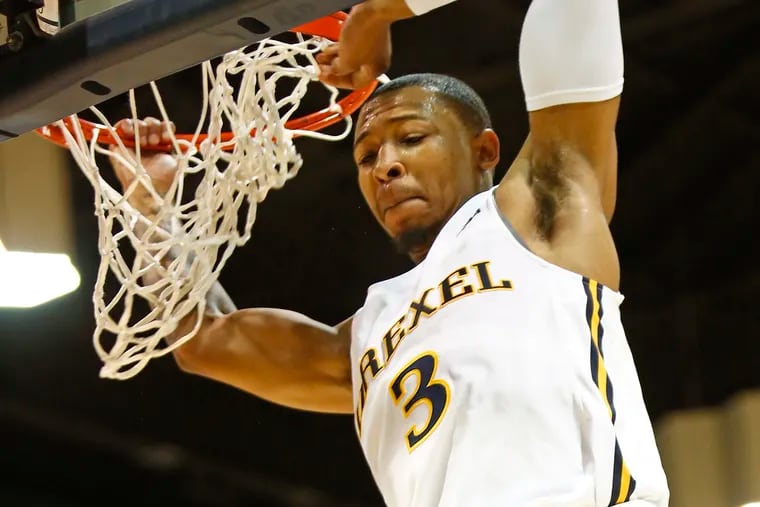 Drexel guard Troy Harper holds onto the rim after dunking against William and Mary in the first half of a Colonial Athletic Association basketball game Saturday, Jan. 5, 2019, at the Daskalakis Athletic Center. LOU RABITO / Staff