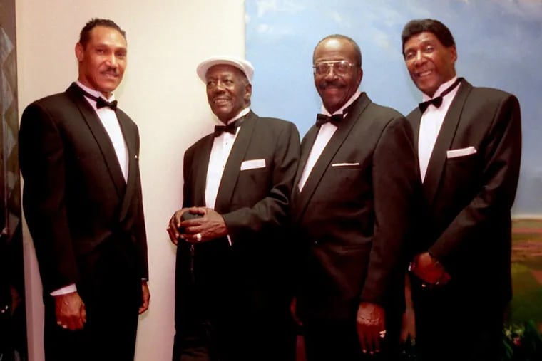 Howard Alexander Carroll, 92, (wearing the  white hat) an original member of the Dixie Hummingbirds died in Philadelphia on Tuesday, October 17, 2017. He is pictured here. from left to right, with Carl Davis, Ira Tucker and Paul Owens during an anniversary event at African American Museum on June 28, 1998,