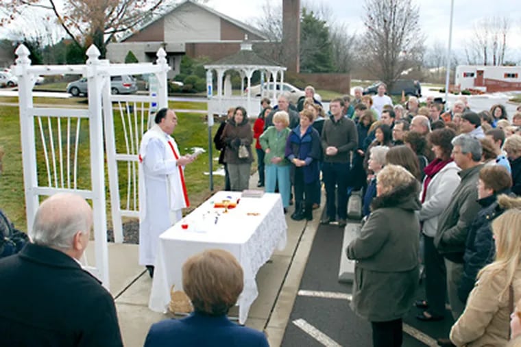 Monsignor Robert Powell conducts Mass in the parking lot of St. Cyril
of Jerusalem Catholic Church in Warwick, Bucks County. (Photo by Tom Kelly III)