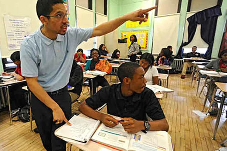 Kareem Demetrius Edwards explains an algebra problem for ninth grader Malik Hashim at Parkway West High in this May 2010 file photo. School officials said Wednesday that the district's classrooms have 70,000 empty seats. (Clem Murray/File)
