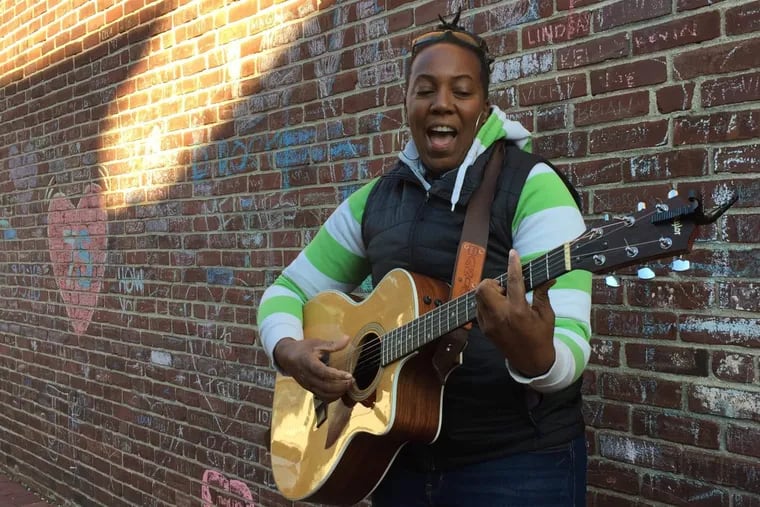 Danie Ocean, 33, performs outside of Seven Stones cafe in Media.