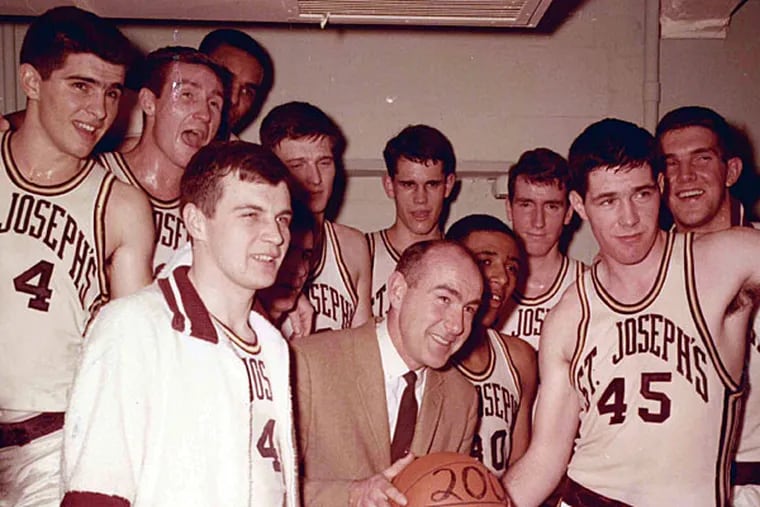 This undated photo provided by Saint Joseph's University shows the school's basketball coach Jack Ramsay, center, when his team won his 200th career game. Ramsay, a Hall of Fame coach who led the Portland Trail Blazers to the 1977 NBA championship before he became one of the league's most respected broadcasters, has died following a long battle with cancer. He was 89. (AP Photo/Saint Joseph's University)