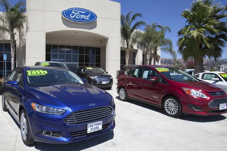 A Ford Fusion, left, and a C-Max Hybrid  are displayed at The Ford Store in Morgan Hill, Calif., in August 2013. (Patrick Tehan/San Jose Mercury News/MCT)