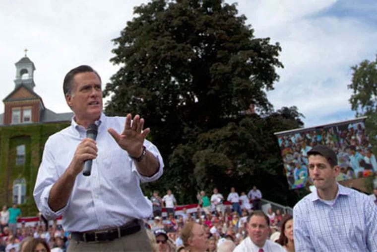 Mitt Romney speaks, Paul Ryan listens on Monday in Manchester, N.H.  (EVAN VUCCI / Associated Press)