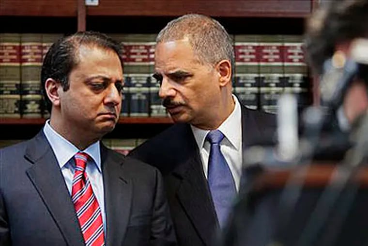 U.S. Attorney General Eric Holder, right, and U.S. Attorney for New York's Southern District Preet Bharara confer at a news conference on Thursday, Jan. 20, 2011, in New York. Law enforcement officials said more than 120 organized crime associates face charges including murder, extortion and narcotics trafficking in one of the largest Mafia crackdowns in FBI history. (AP Photo/Bebeto Matthews)