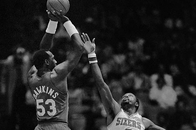 In this April 20, 1984, file photo, New Jersey Nets' Darryl Dawkins (53) towers over Philadelphia 76ers' Moses Malone (2) as he gets off.