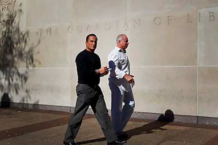 Antony Borgesi, at left, who is the nephew of Joseph Ligambi walks back into the Federal courthouse in Philadelphia with an unidentified man on October 18, 2012. Mob boss Joseph Ligambi and six others are facing racketeering conspiracy charges built around allegations of illegal gambling, loan-sharking, and extortion that extend back to 1999. ( DAVID MAIALETTI / Staff Photographer )