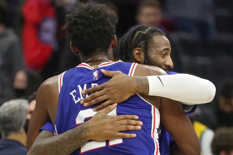 Andrew Drummond hugs Joel Embiid when they were teammates with the Sixers during the 2021-22 season.
