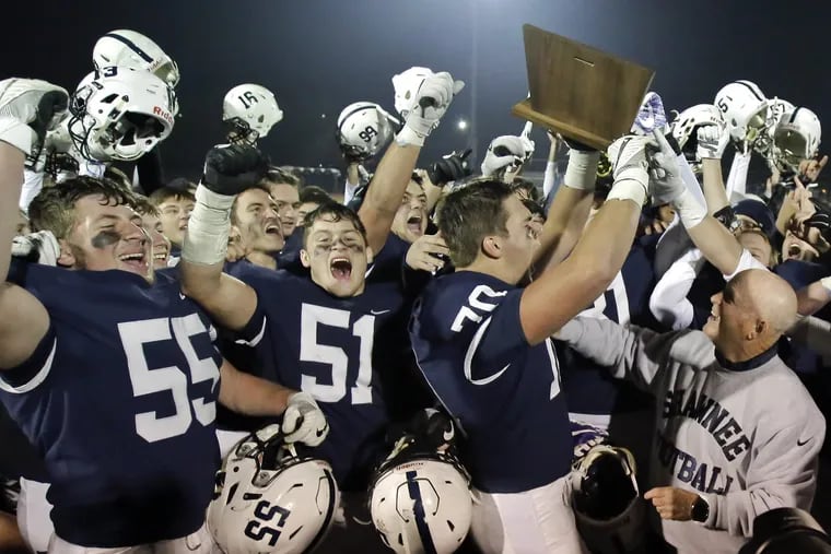 Shawnee football players  and coach Tim Gushue celebrate last season's South Jersey Group 4 title. This season, the sectional champions will play another game, facing the Central Jersey winners in so-called "Bowl Games."