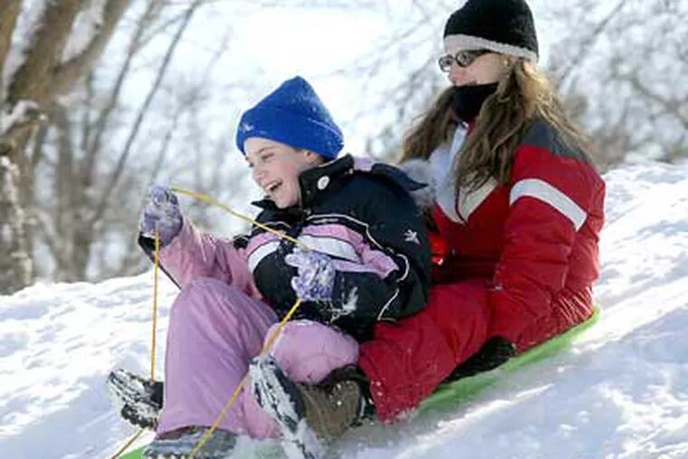 Melissa Trout, 10, goes sledding with little brother, Aidan, 5, on Wednesday.  (April Saul / Staff Photographer)