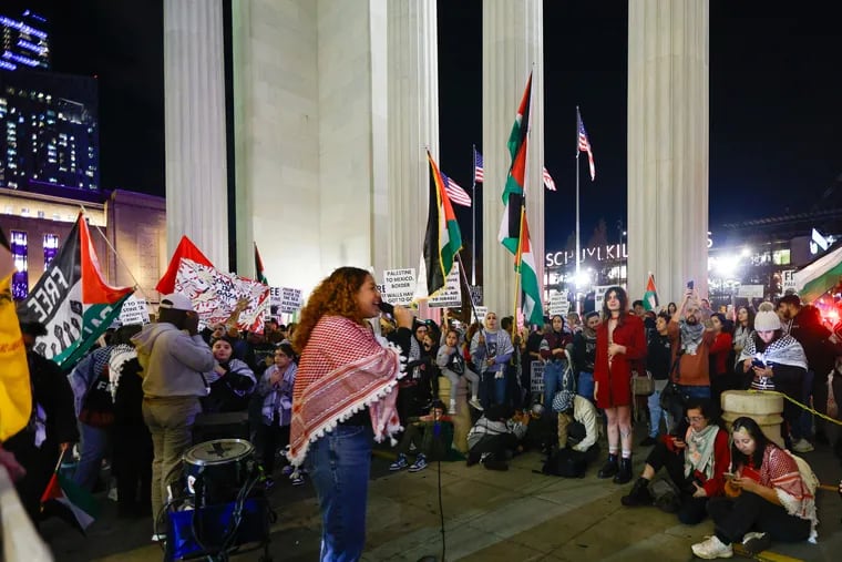 Xiomara Torres (left) and pro-Palestinian protesters rally outside of 30th Street Station on Friday in Philadelphia.