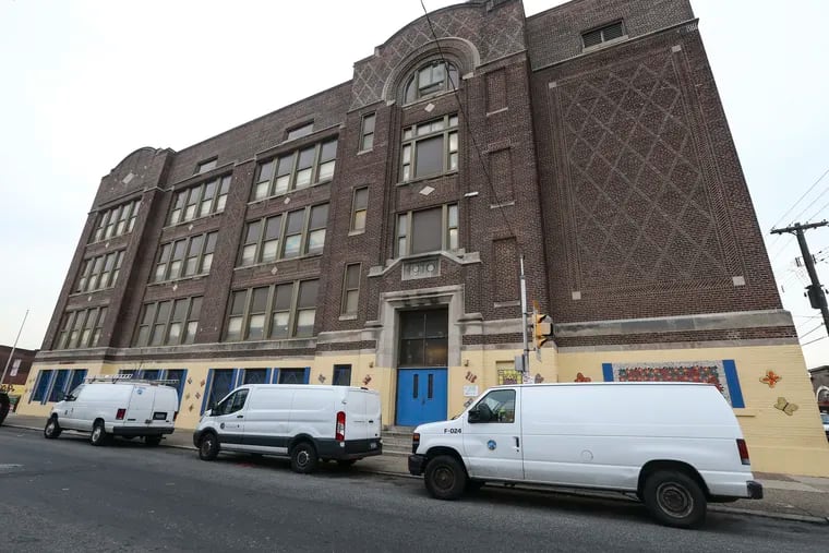 School district vans working on an asbestos job at McClure Elementary in Hunting Park are shown in this file photo. The city has hired an environmental firm to oversee asbestos jobs in the Philadelphia School District and to bring the PFT and district to consensus on how to handle such work going forward.