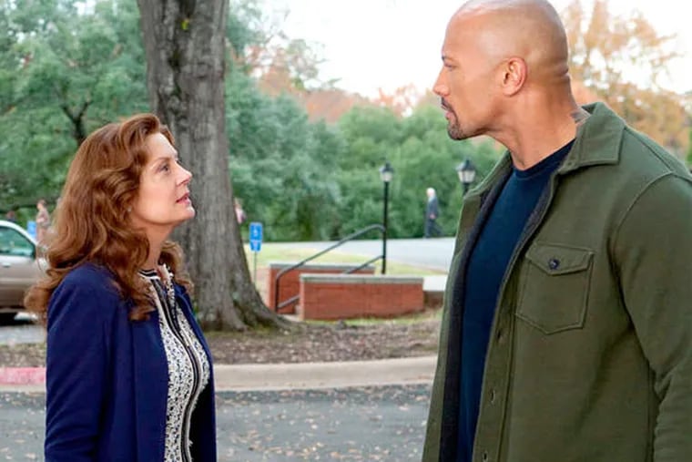 Dwayne Johnson (right) deals with a U.S. attorney (Susan Sarandon) and works with a DEA agent (Barry Pepper) to keep his son out of jail.