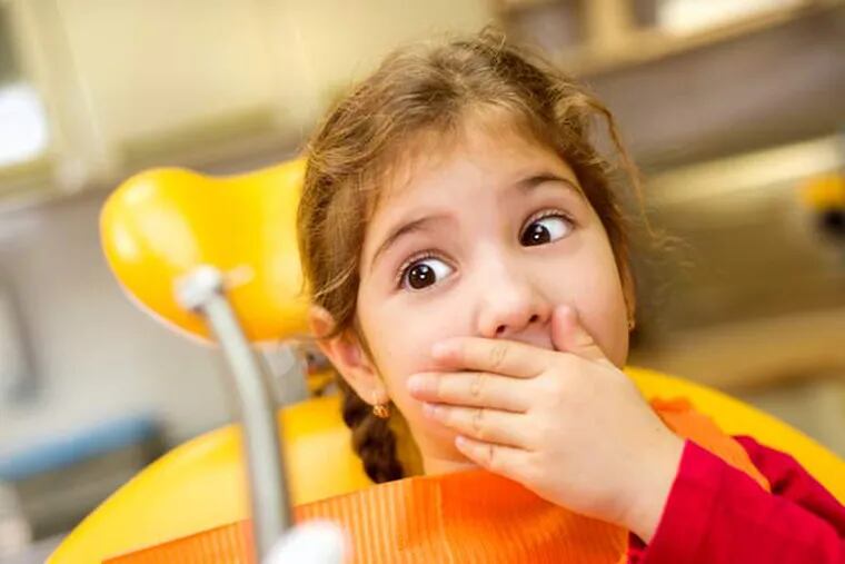 Young girl at the dentist.