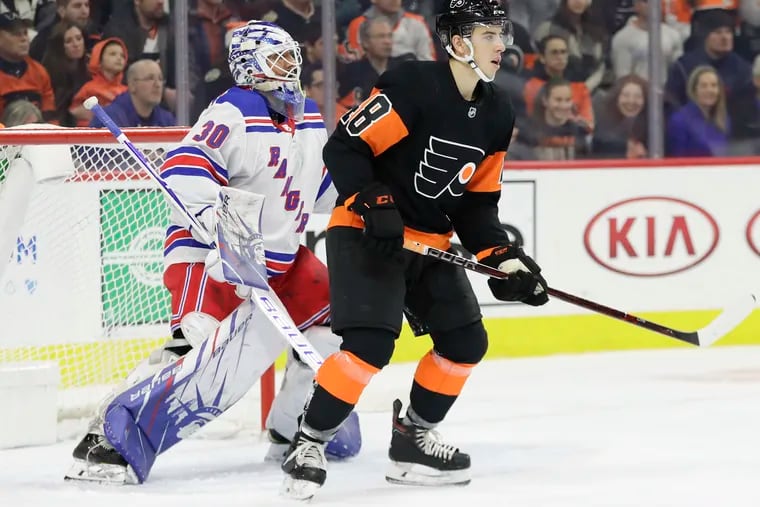 Flyers center Morgan Frost, standing in front of New York Rangers goaltender Henrik Lundqvist in a Dec. 23 game, will be battling for a regular spot in next season's lineup. He has seven points in 20 NHL games this season.