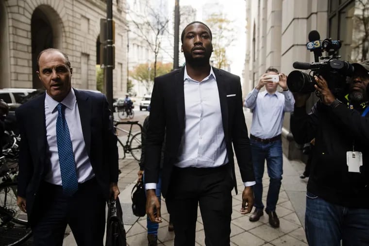 Rapper Meek Mill, center, accompanied by defense attorney Brian McMonagle, arrives at the criminal justice center in Philadelphia, Monday, Nov. 6, 2017.