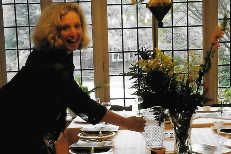 Daughter Jill Friedman checks over her Passover table.